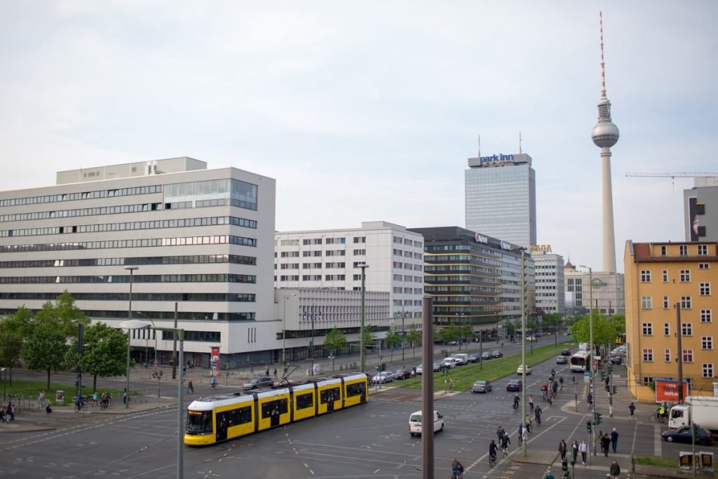 Tram is passing in front of the TV tower in Berlin Germany