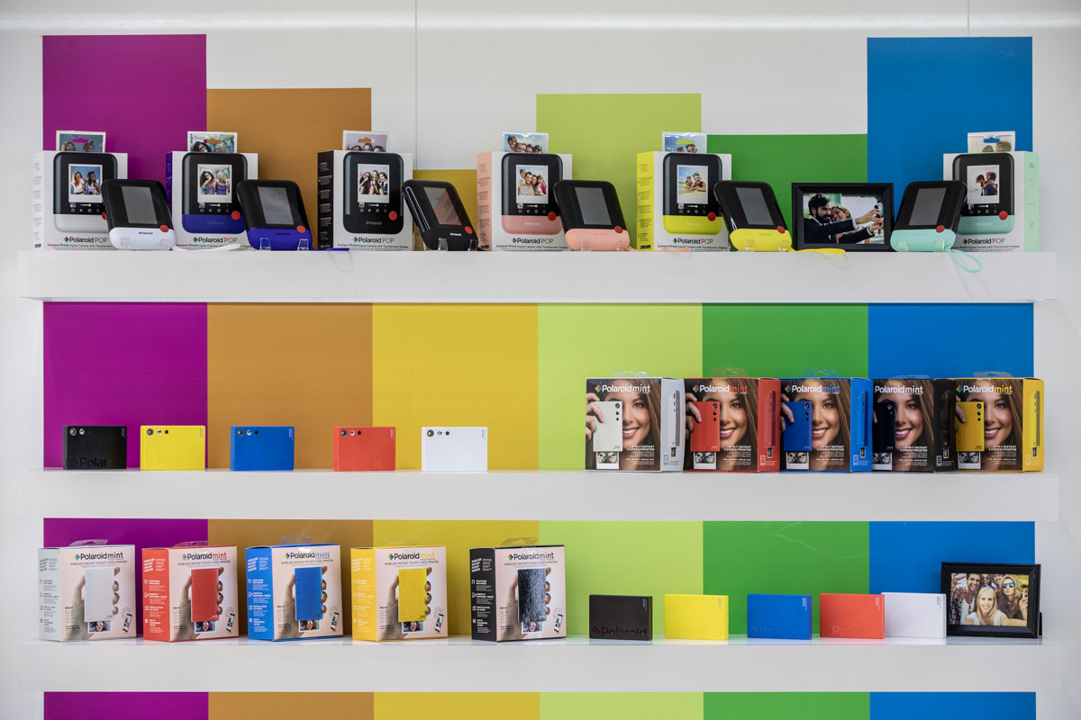Polaroid at IFA Berlin 2018 — Product display Instant cameras, printers and product packaging arranged on colourful display shelves at IFA Berlin 2018