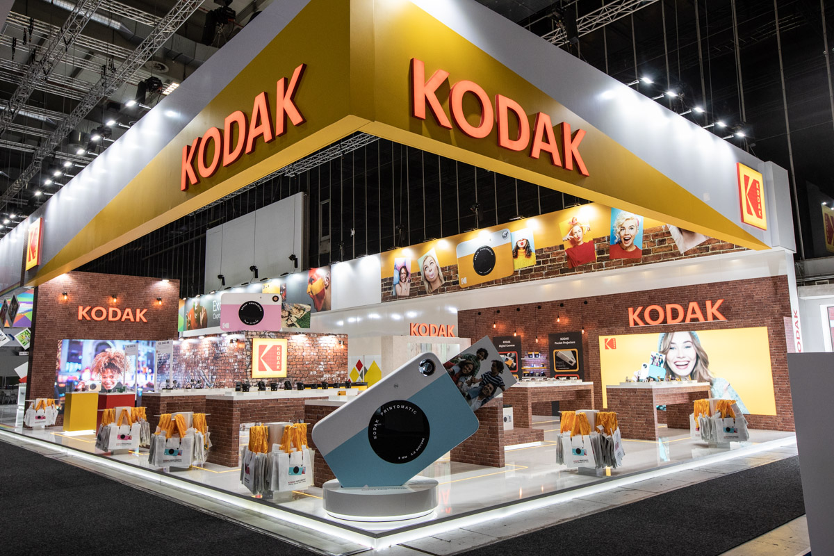 Kodak at IFA Berlin 2018 — Stand architecture Corner view of the Kodak stand with overhead branding and an oversized camera model at IFA Berlin 2018