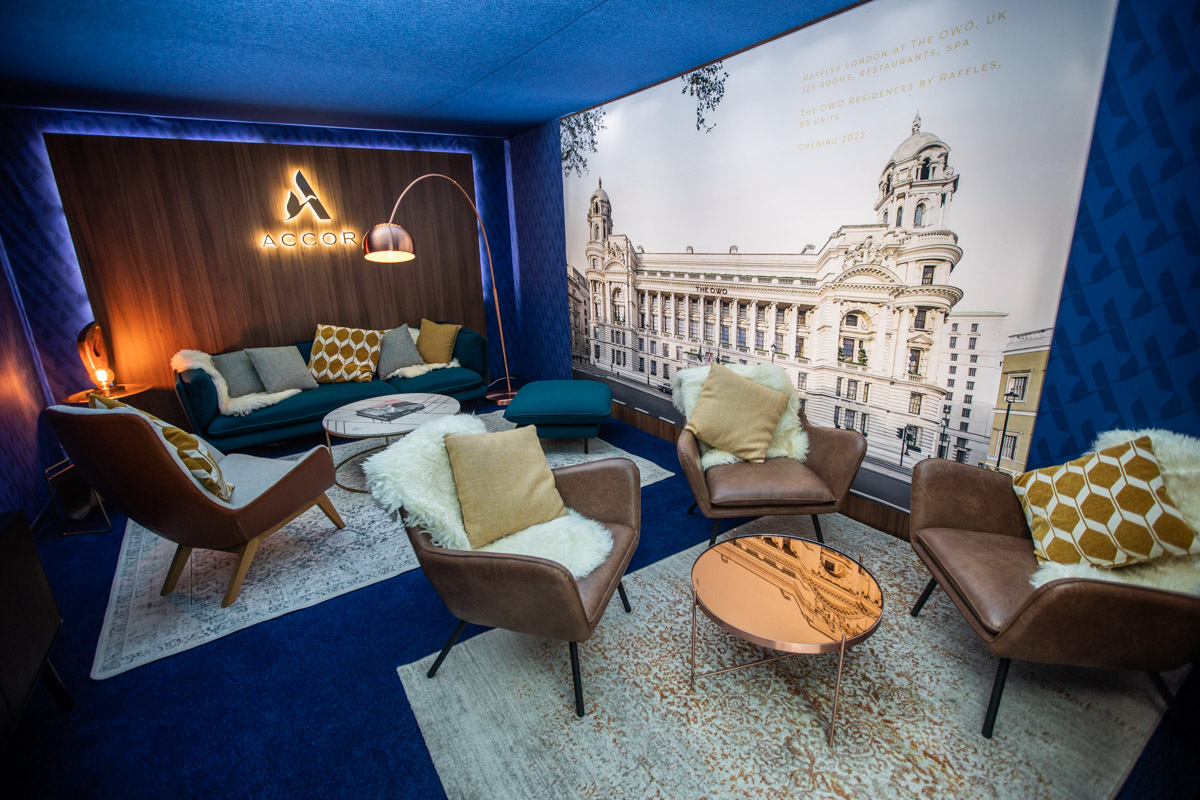 Accor at IHIF Berlin 2021 — Hospitality design Blue lounge with armchairs, a sofa and an architectural wall mural at IHIF Berlin 2021