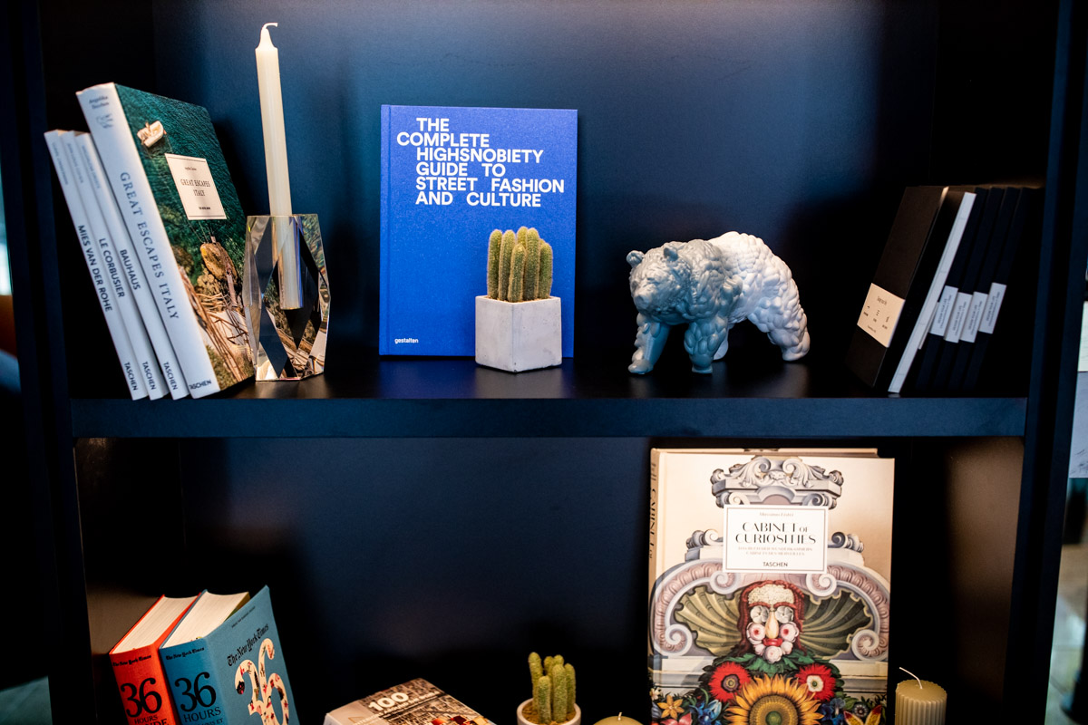 Accor at IHIF Berlin 2021 — Interior styling Books, glassware and decorative objects arranged on a display shelf at IHIF Berlin 2021
