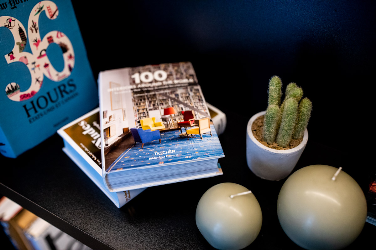 Accor at IHIF Berlin 2021 — Styling detail Books and a cactus arranged on a side table in the exhibition lounge at IHIF Berlin 2021