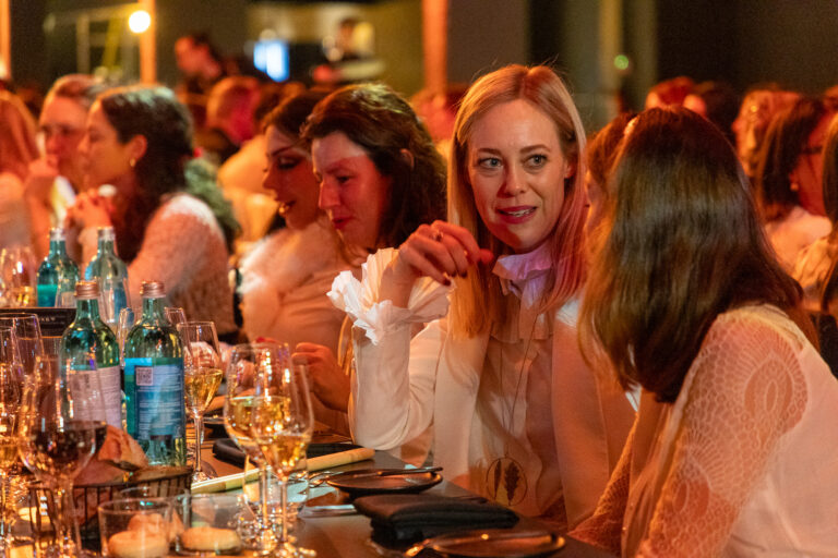 Guests sharing a moment at the gala dinner table