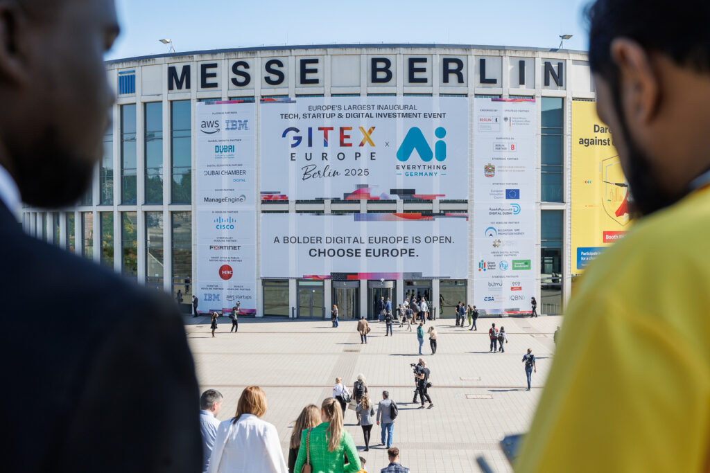 20250521_GITEX_Europe_Messe_Berlin_Entrance.jpg GITEX Europe 2025 banner at Messe Berlin entrance with attendees arriving at the tech trade fair.